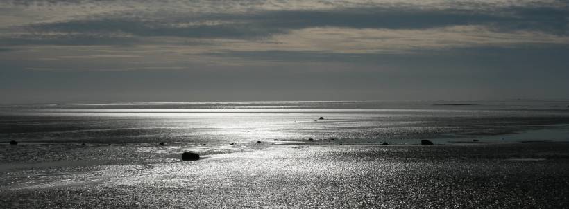 Sunlight reflecting of wet sand in Morecambe Bay.